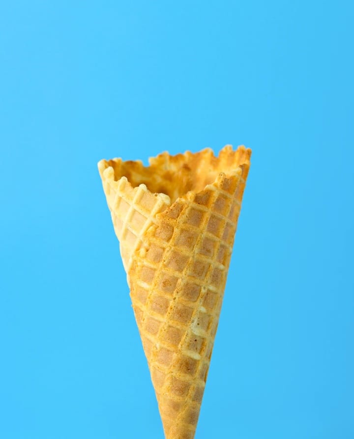 empty ice cream bottle in a blue background.