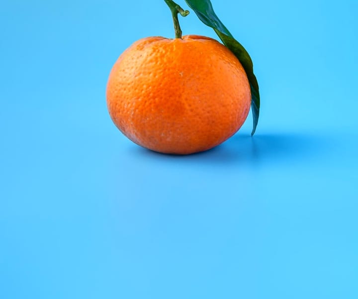 Orange fruit on a blue surface